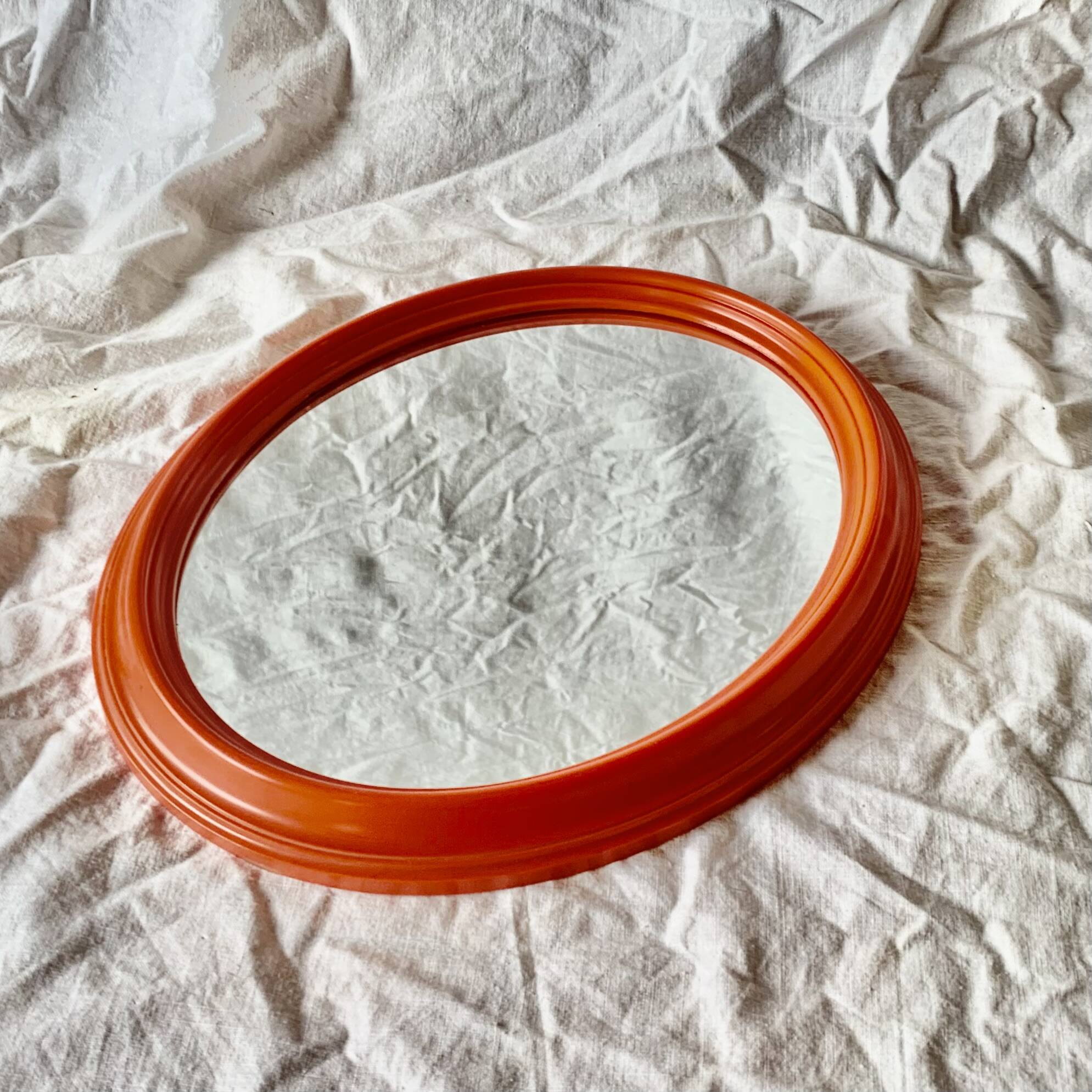 Vintage orange plastic oval wall mirror