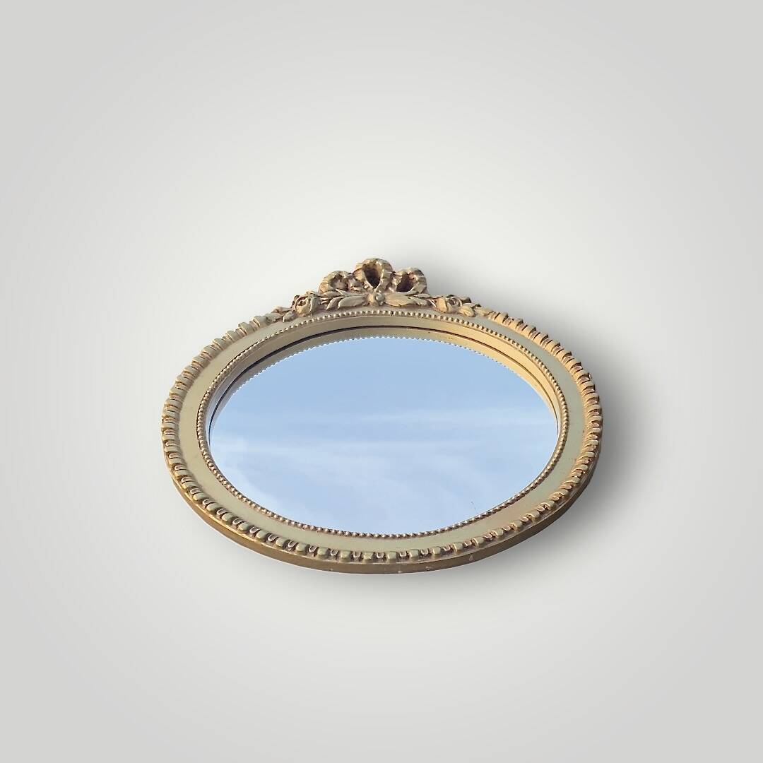 Antique small round wall mirror in gold resin - love knot