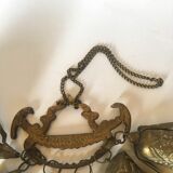 Wall decoration of brass and wood amulets