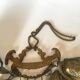 Wall decoration of brass and wood amulets
