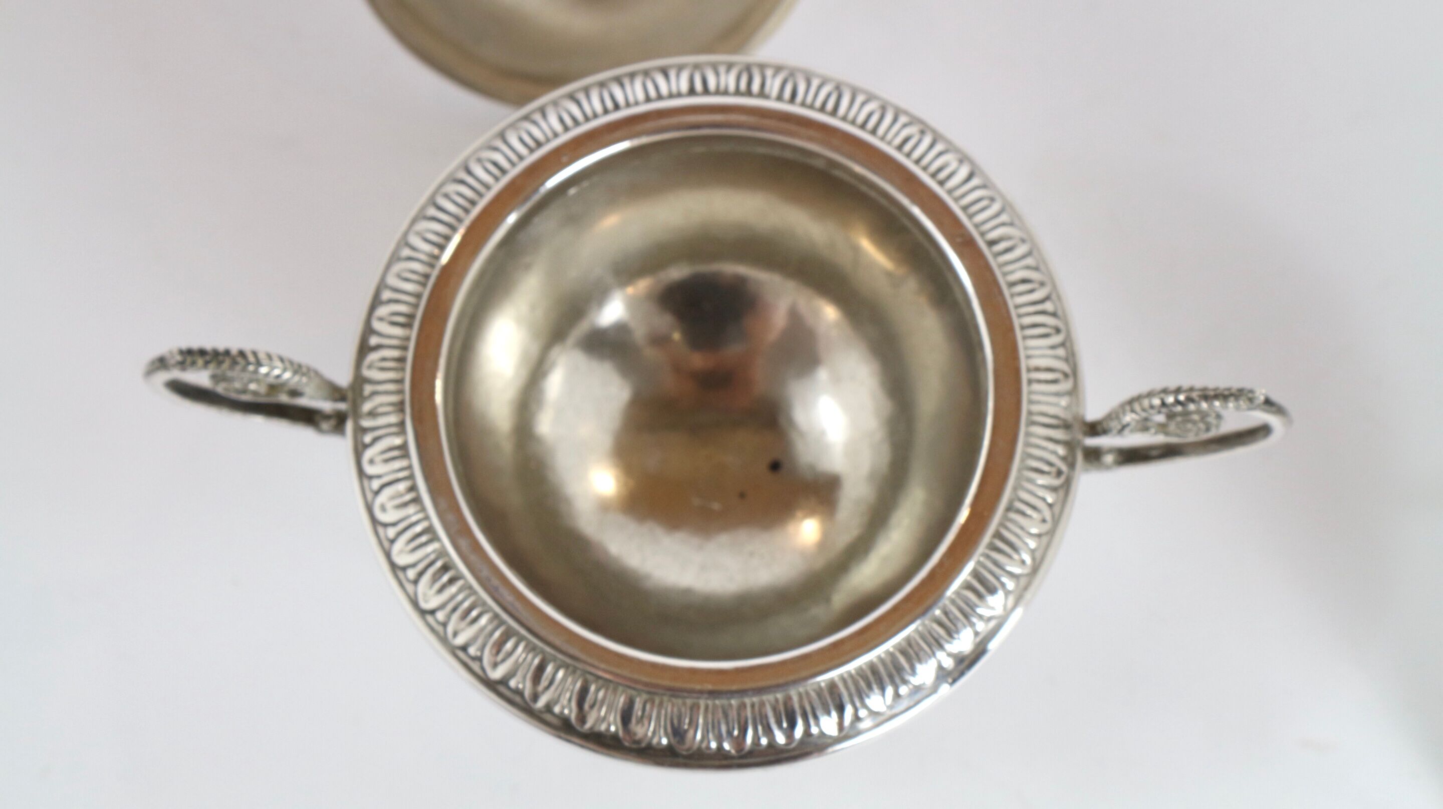 Silver sugar bowl with paw feet and ornate handles