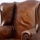 Wingback armchair in dark brown patinated leather, 1970s