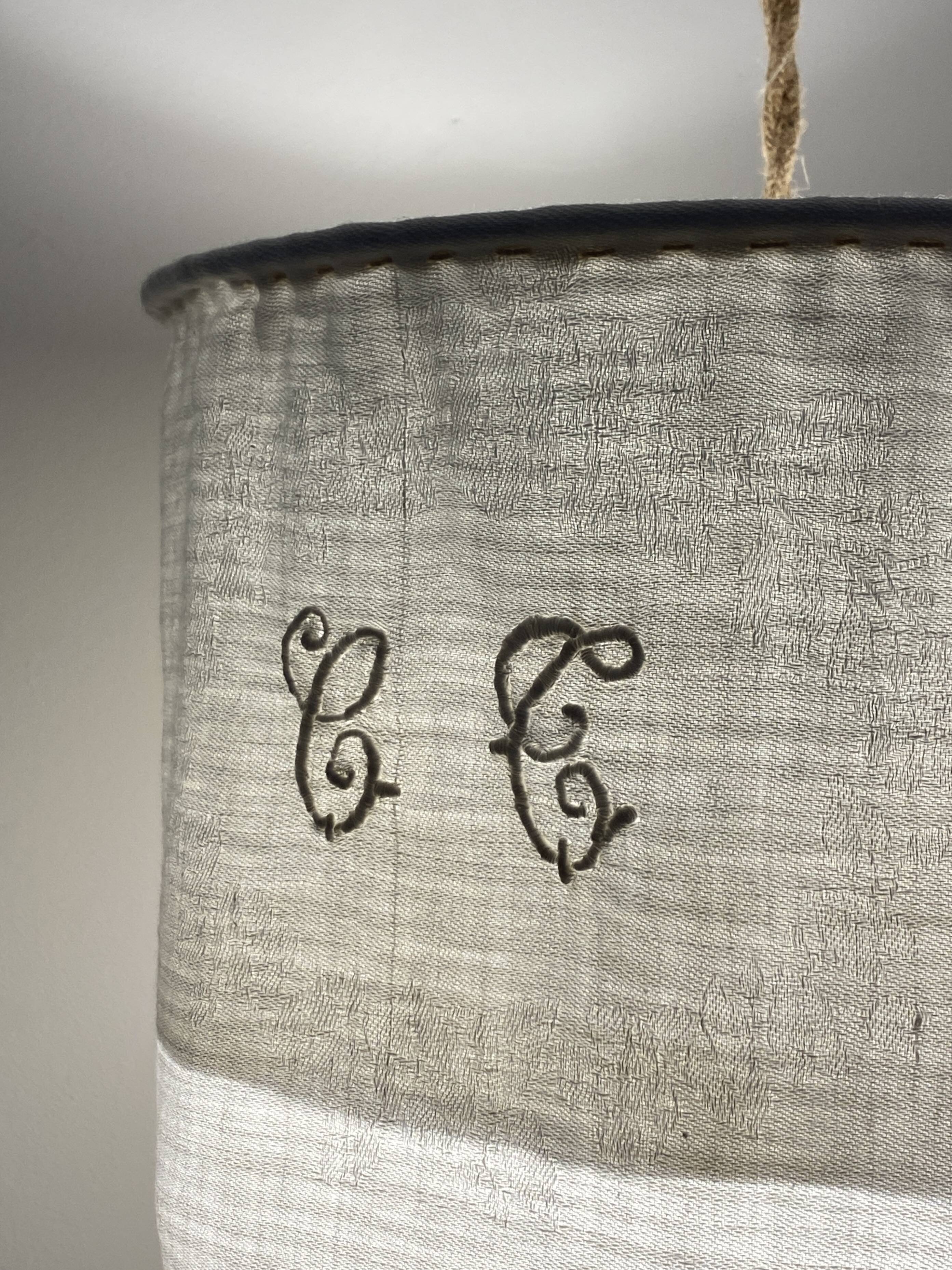 Old linen drapery with monogram and bird by Georges Braque