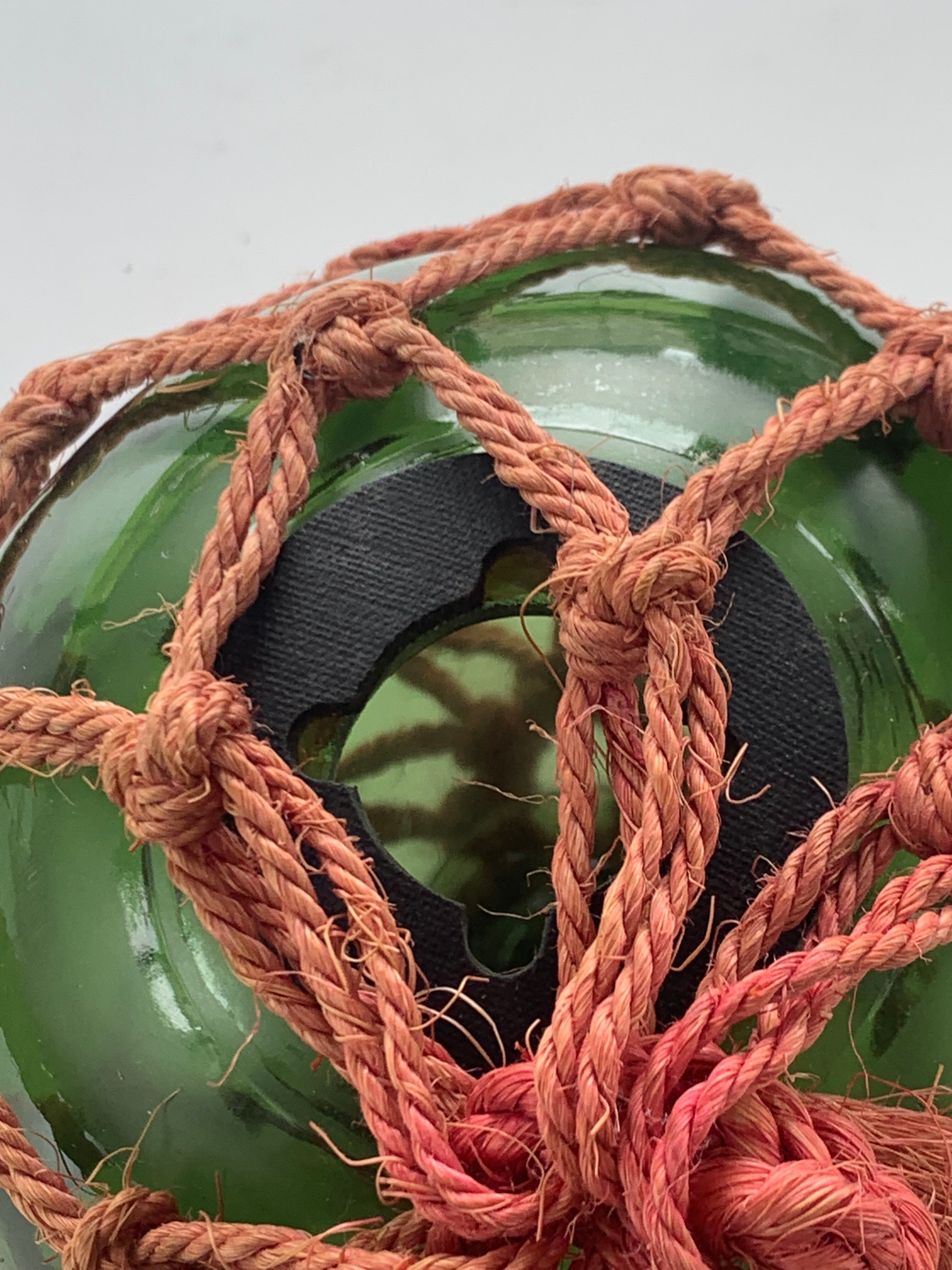 Globe, green glass float and vintage rope