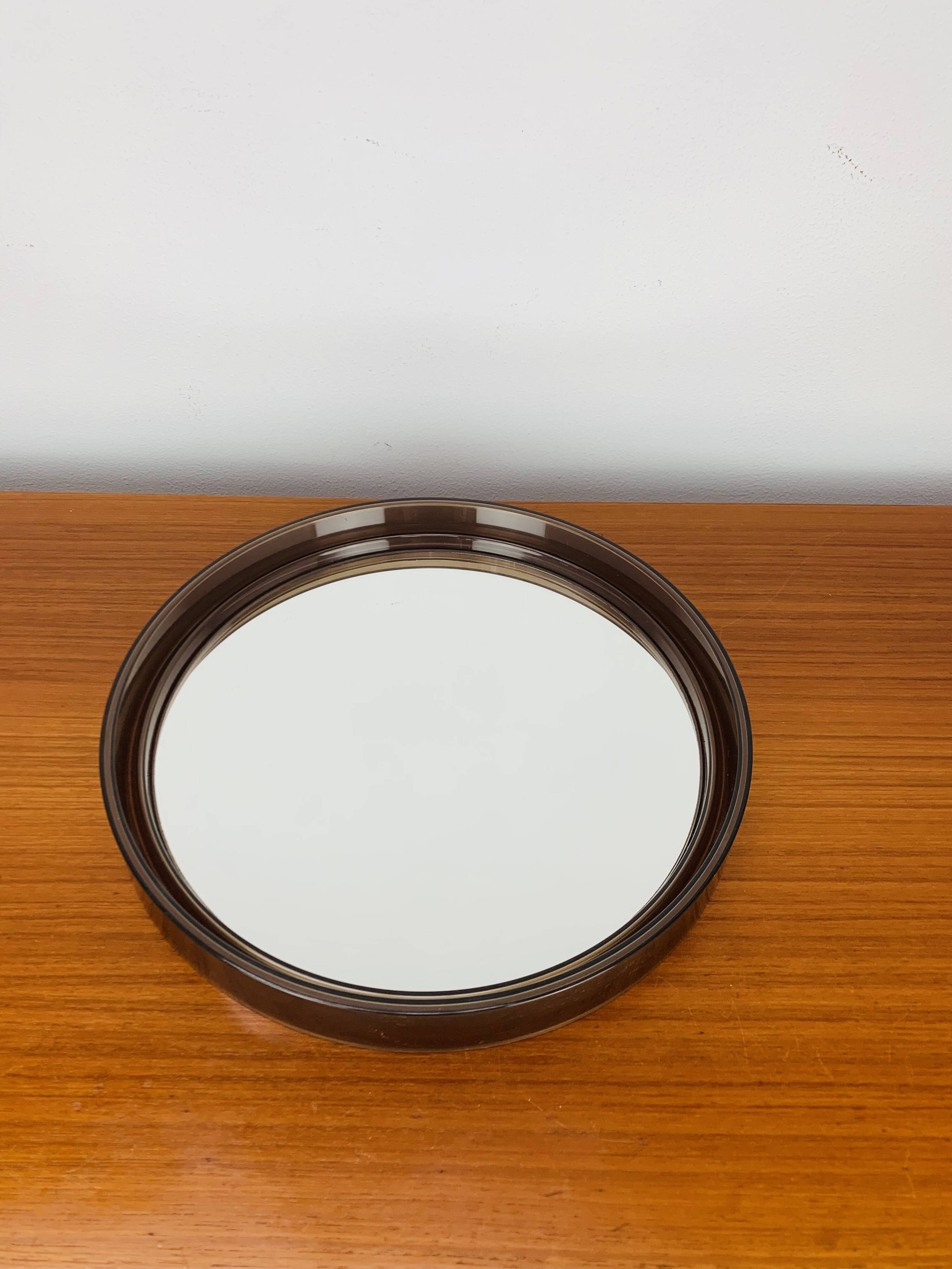 Round mirror with amber rim from the 70s, vintage