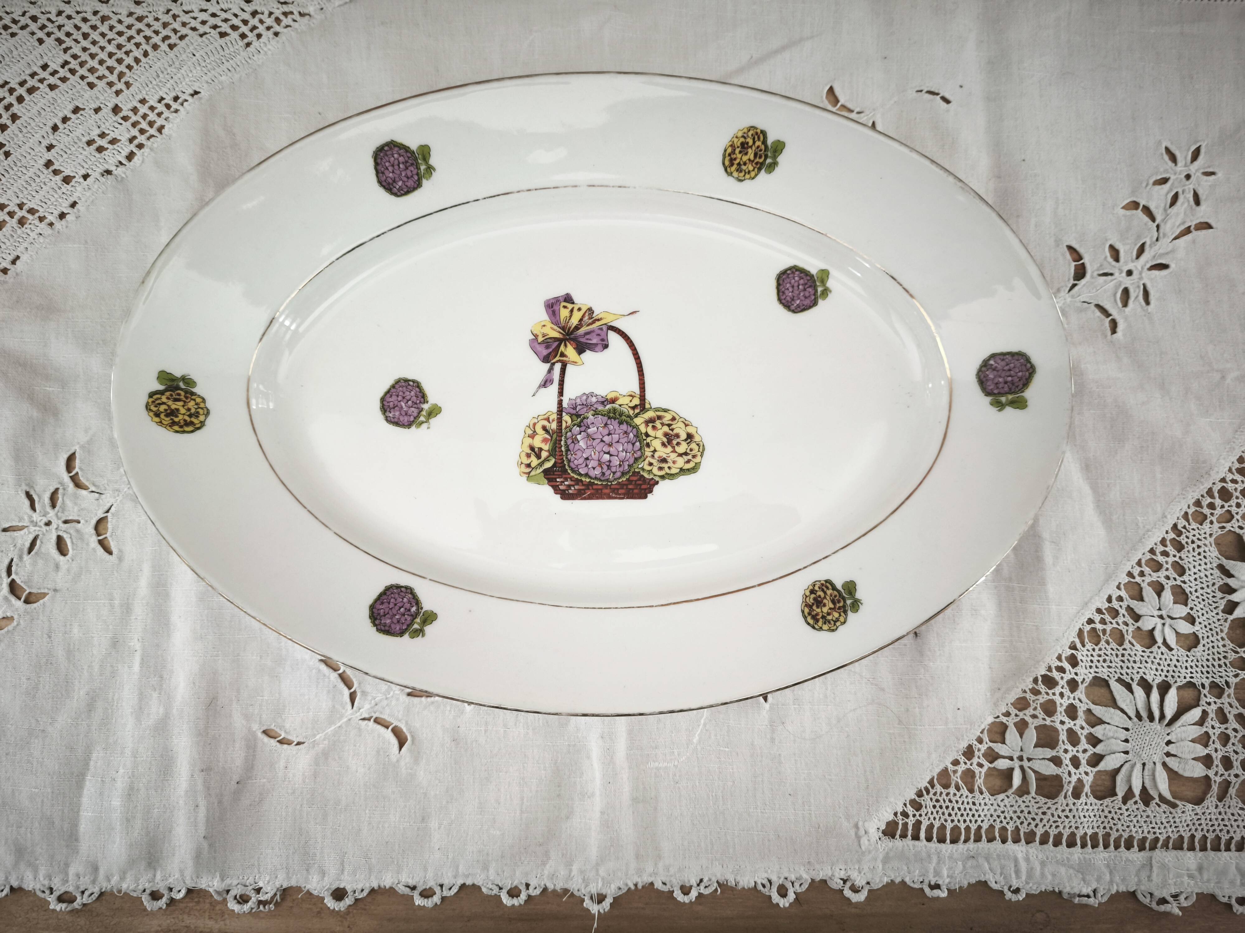 Oval porcelain plate from Limoges with a hydrangea basket design.