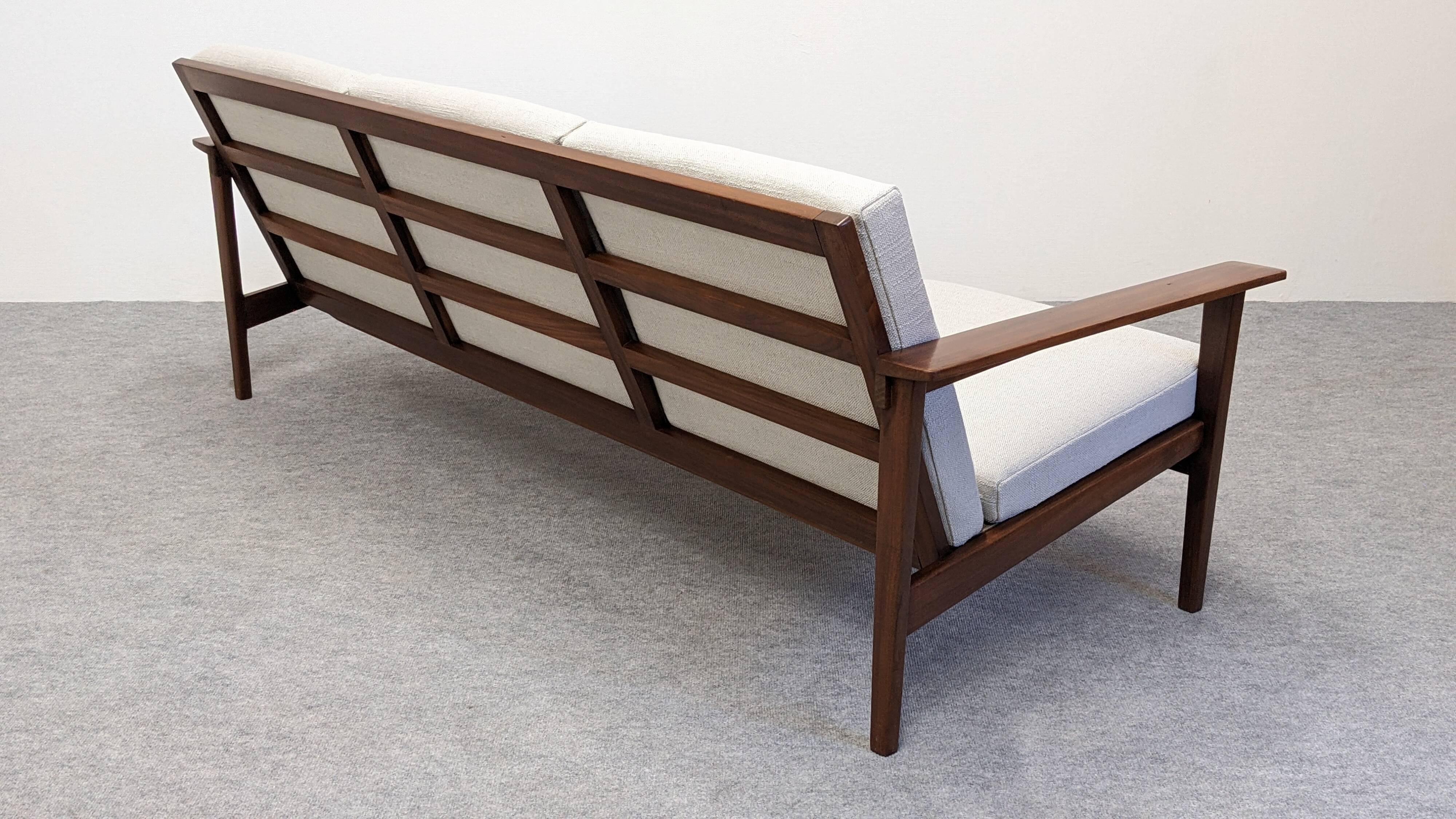 Scandinavian style three-seater sofa in teak, France circa 1950.