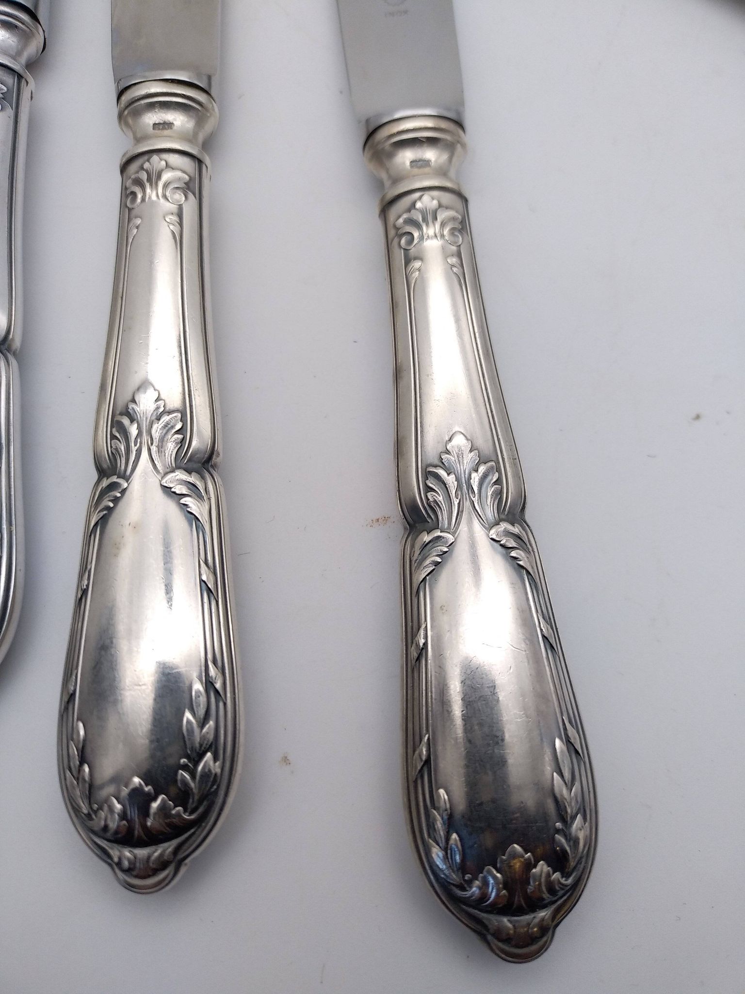 Set of 12 sfam knives in silver metal and stainless steel blades.