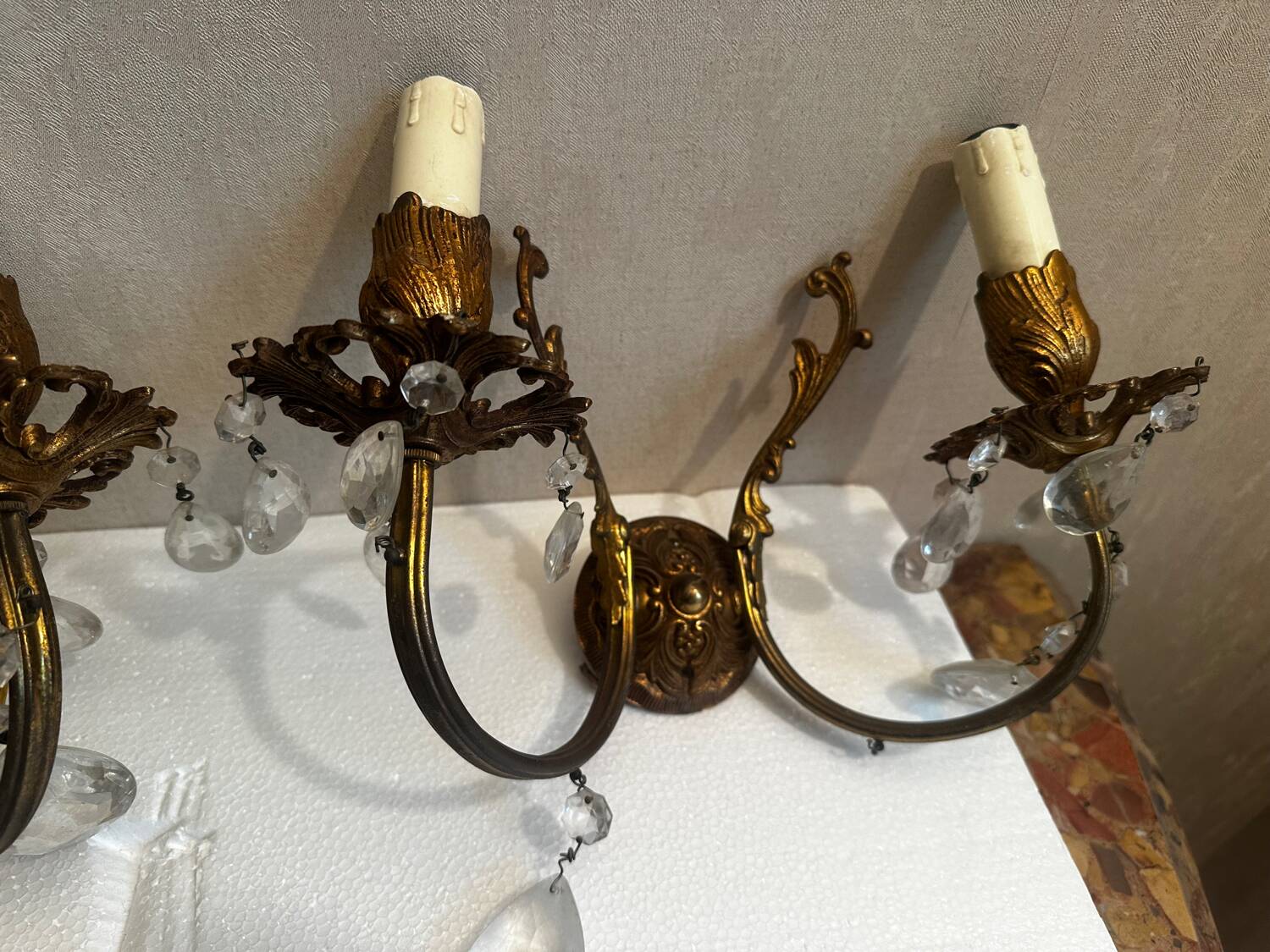 Pair of Louis XV style wall sconces in gilded bronze with glass pendants.