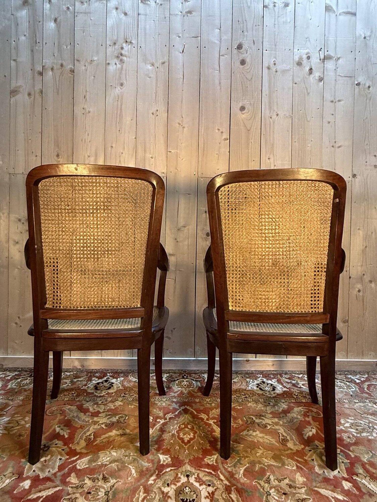 Pair of wide caned armchairs from the Art Nouveau period.
