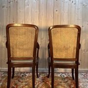 Pair of wide caned armchairs from the Art Nouveau period.