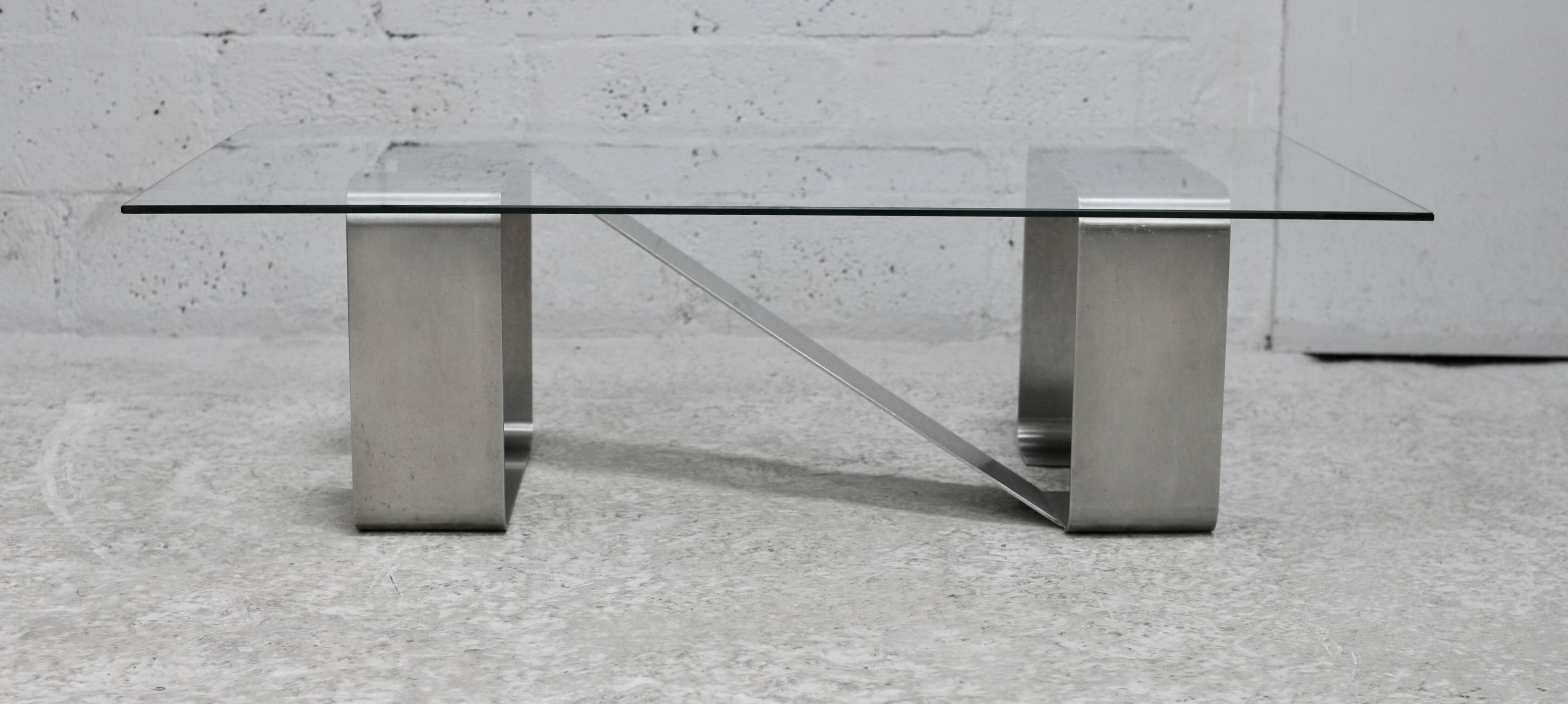 Coffee table with "kinetic" steel base and glass slab. Circa 1970.