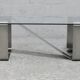 Coffee table with "kinetic" steel base and glass slab. Circa 1970.