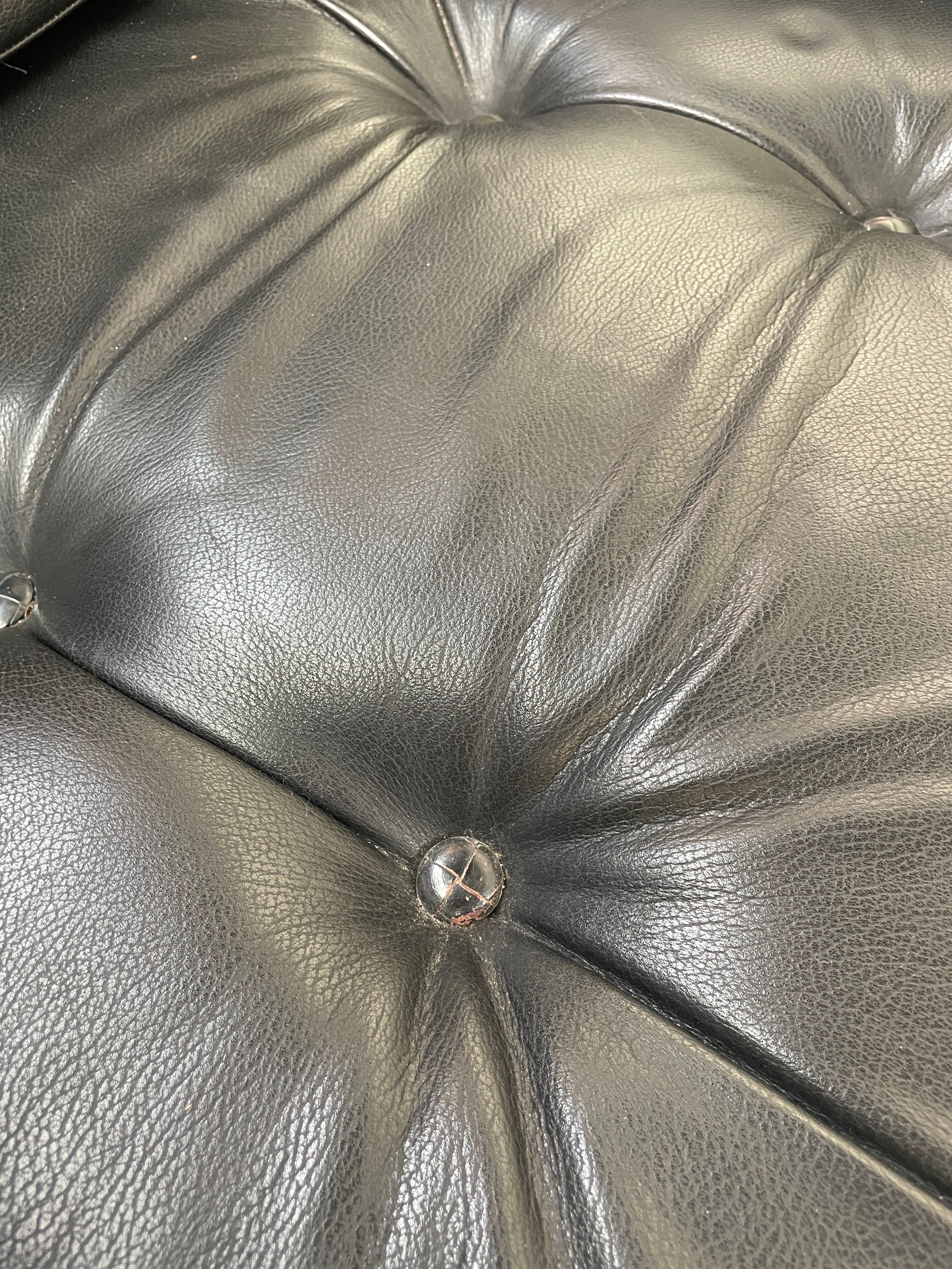 Pair of black leather armchairs