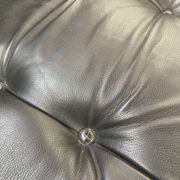 Pair of black leather armchairs