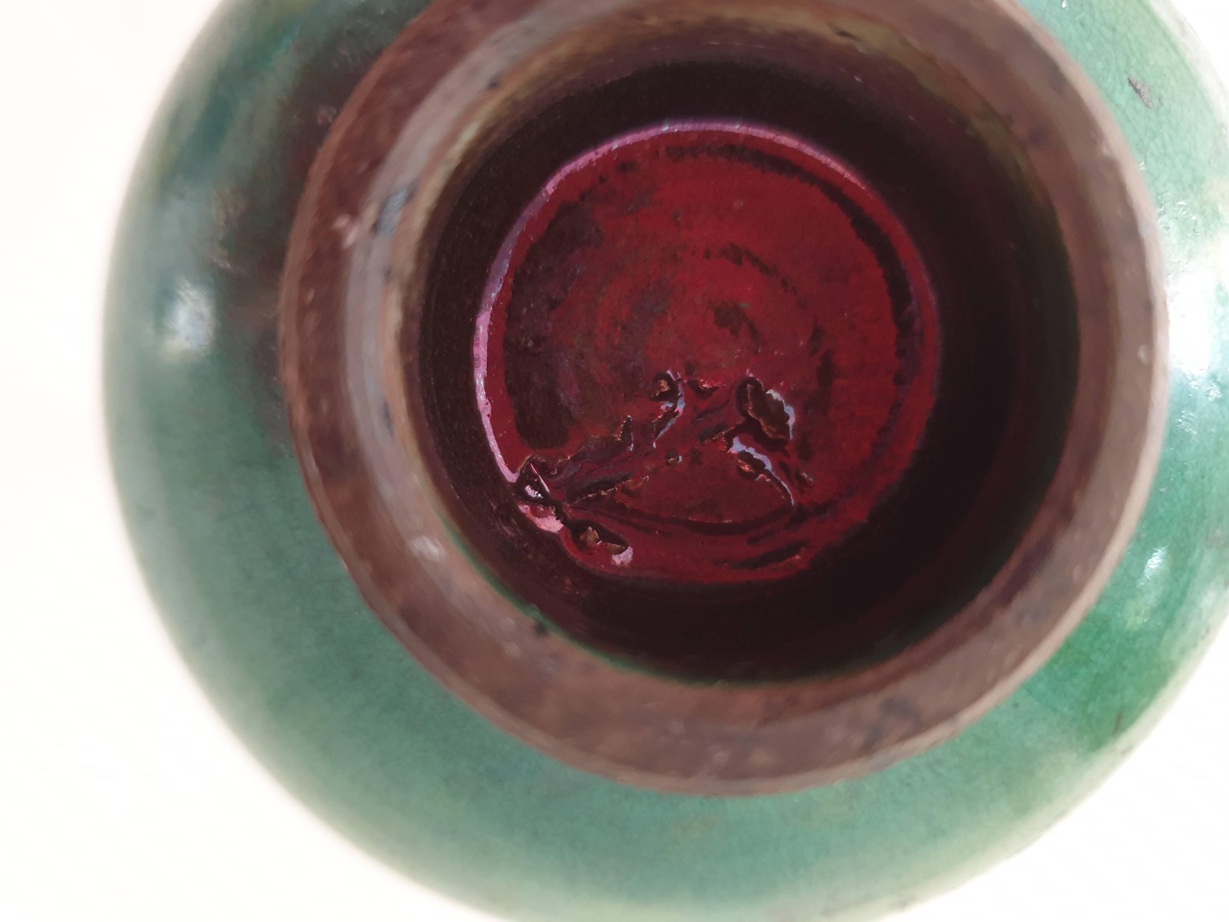 Green pot-bellied ceramic vase with foot and high, narrow neck in signed raku