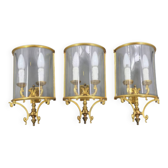 Set of three half-moon wall lights in gilded bronze & curved glass