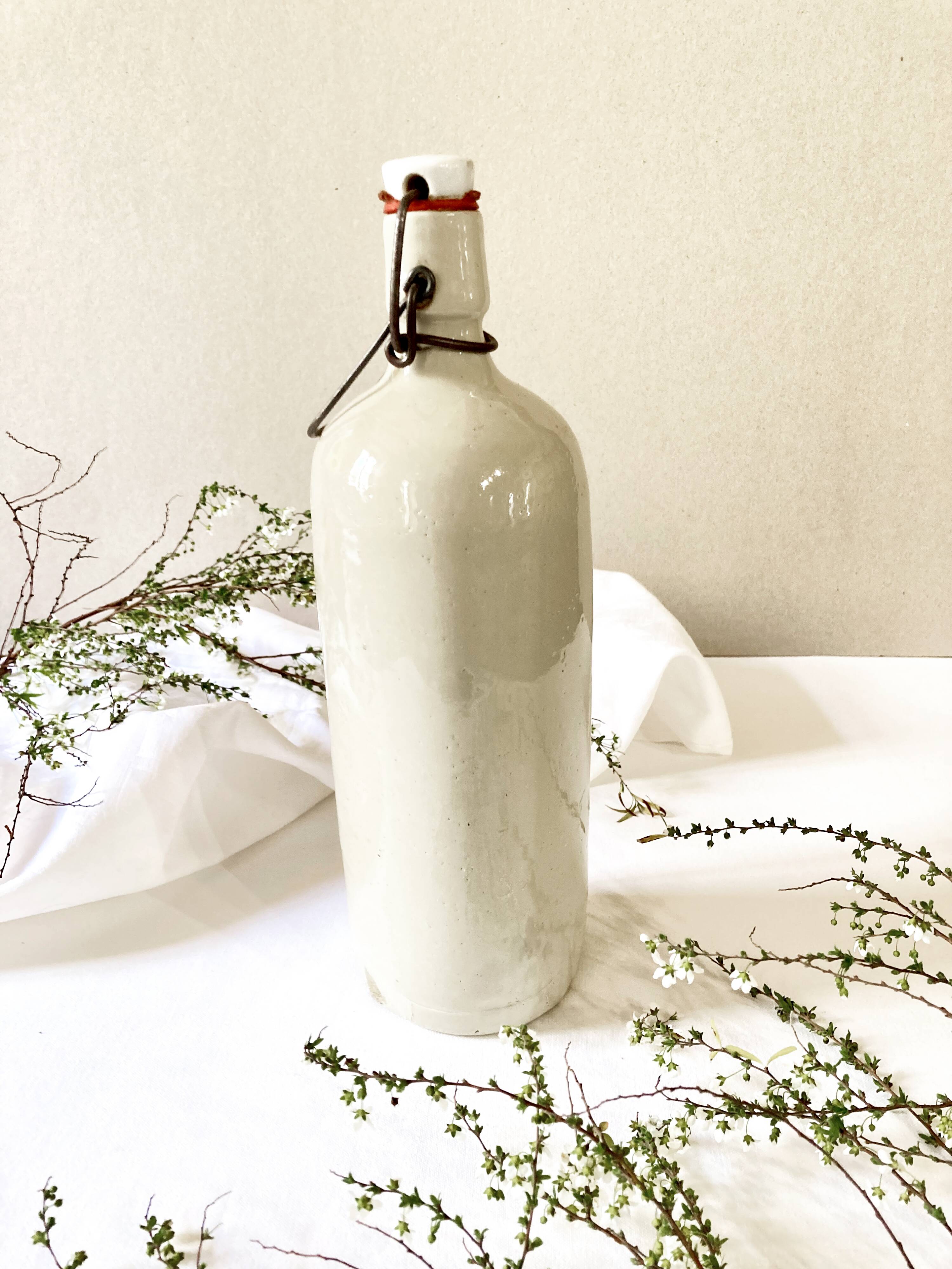 Old light gray enamelled stoneware hot water bottle