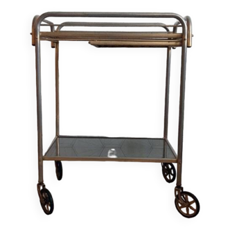 Vintage rolling trolley in gold metal.