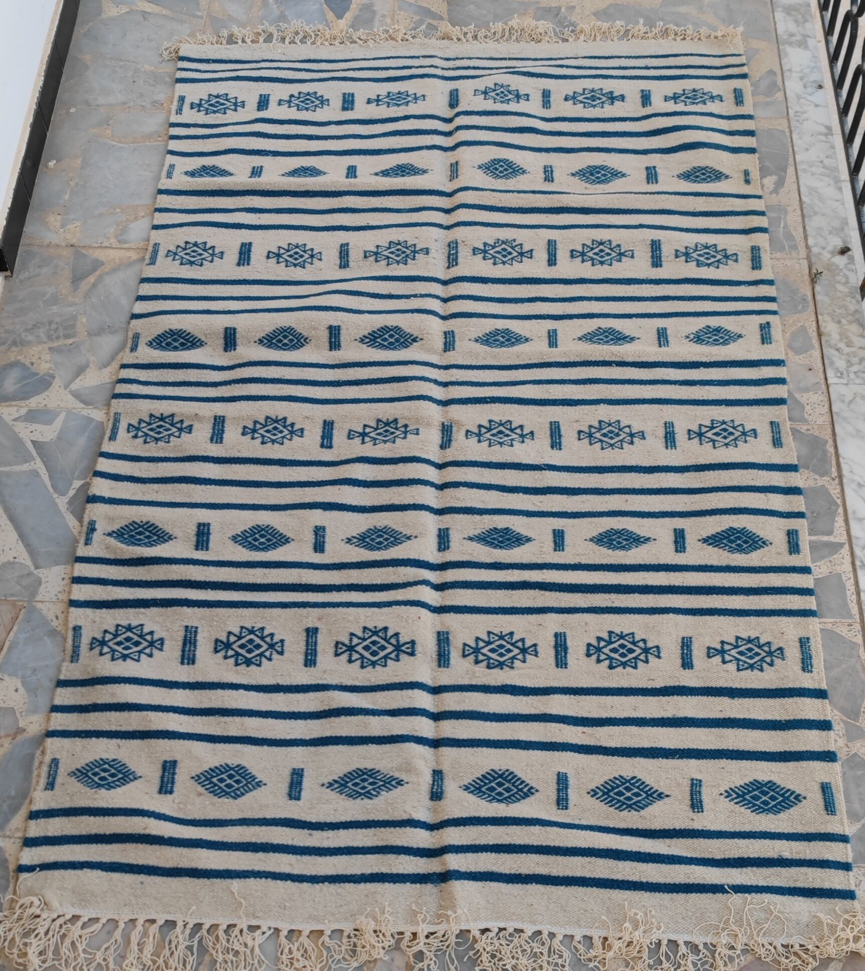 Traditional handmade white and blue kilim rug in natural wool
