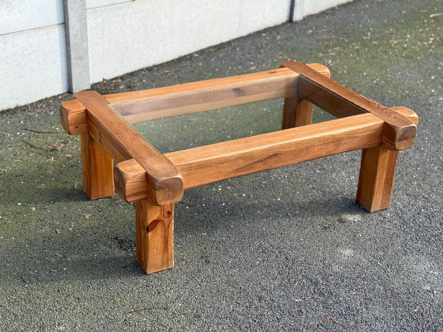 Coffee table with a glass top in Scandinavian brutalist style made of pine.