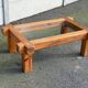 Coffee table with a glass top in Scandinavian brutalist style made of pine.