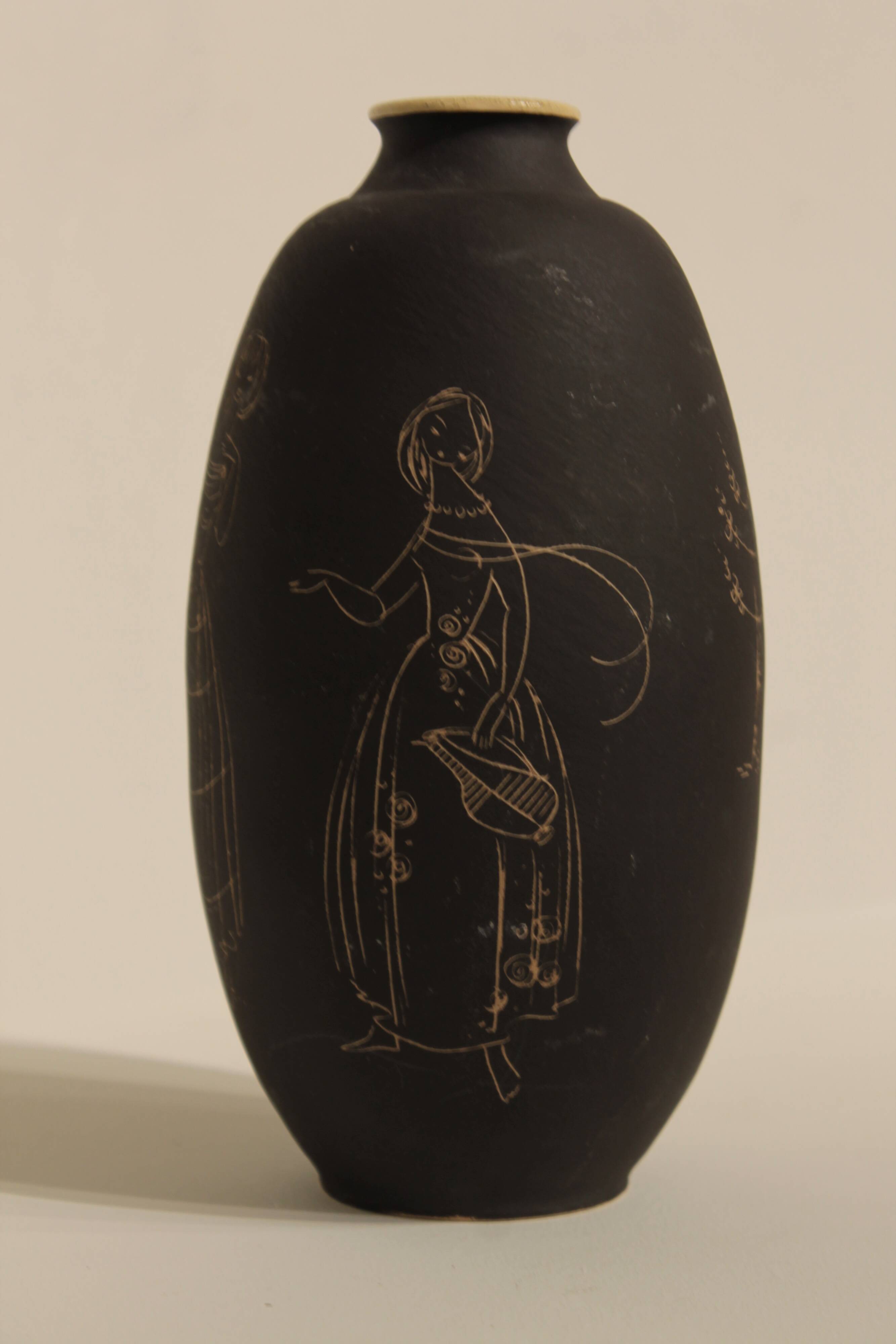 Ceramic vase decorated with women and a tree.