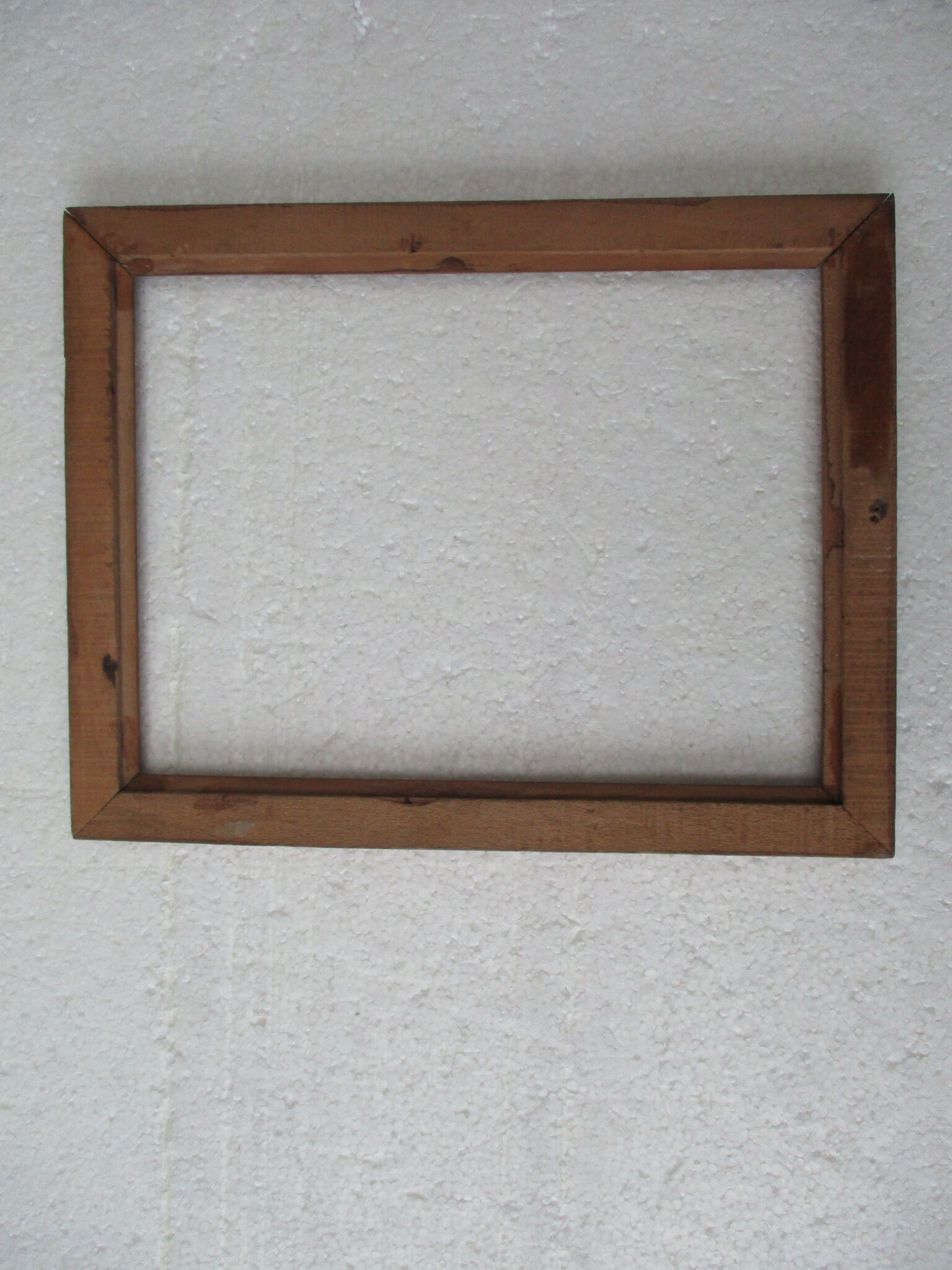 Wooden frame decorated with ribbon and flowers