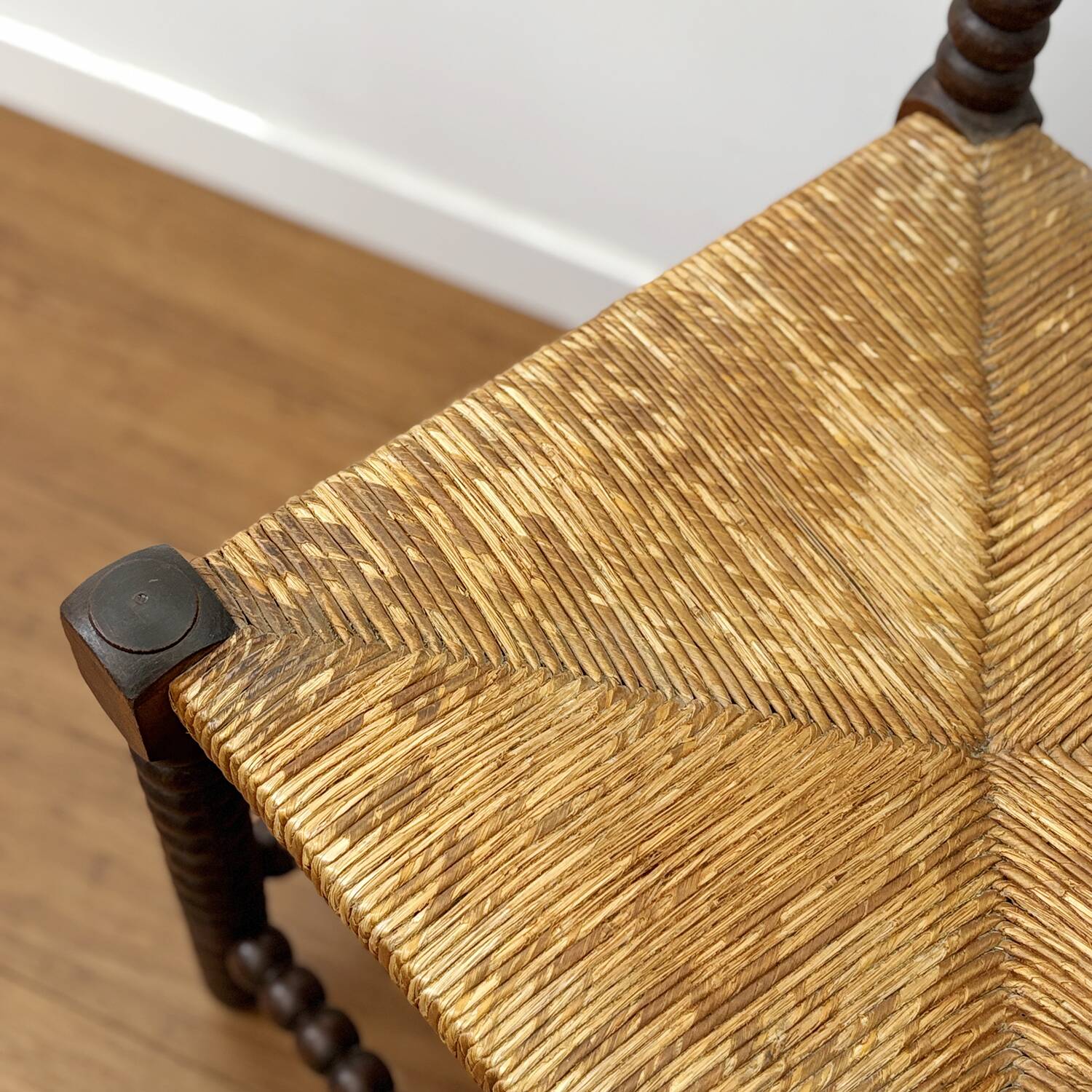 Turned wood corner chair with straw seat