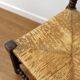 Turned wood corner chair with straw seat