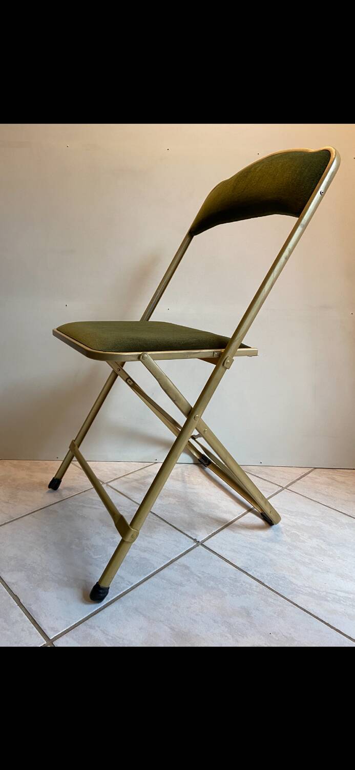 Velvet folding chair with gold metal.