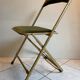 Velvet folding chair with gold metal.