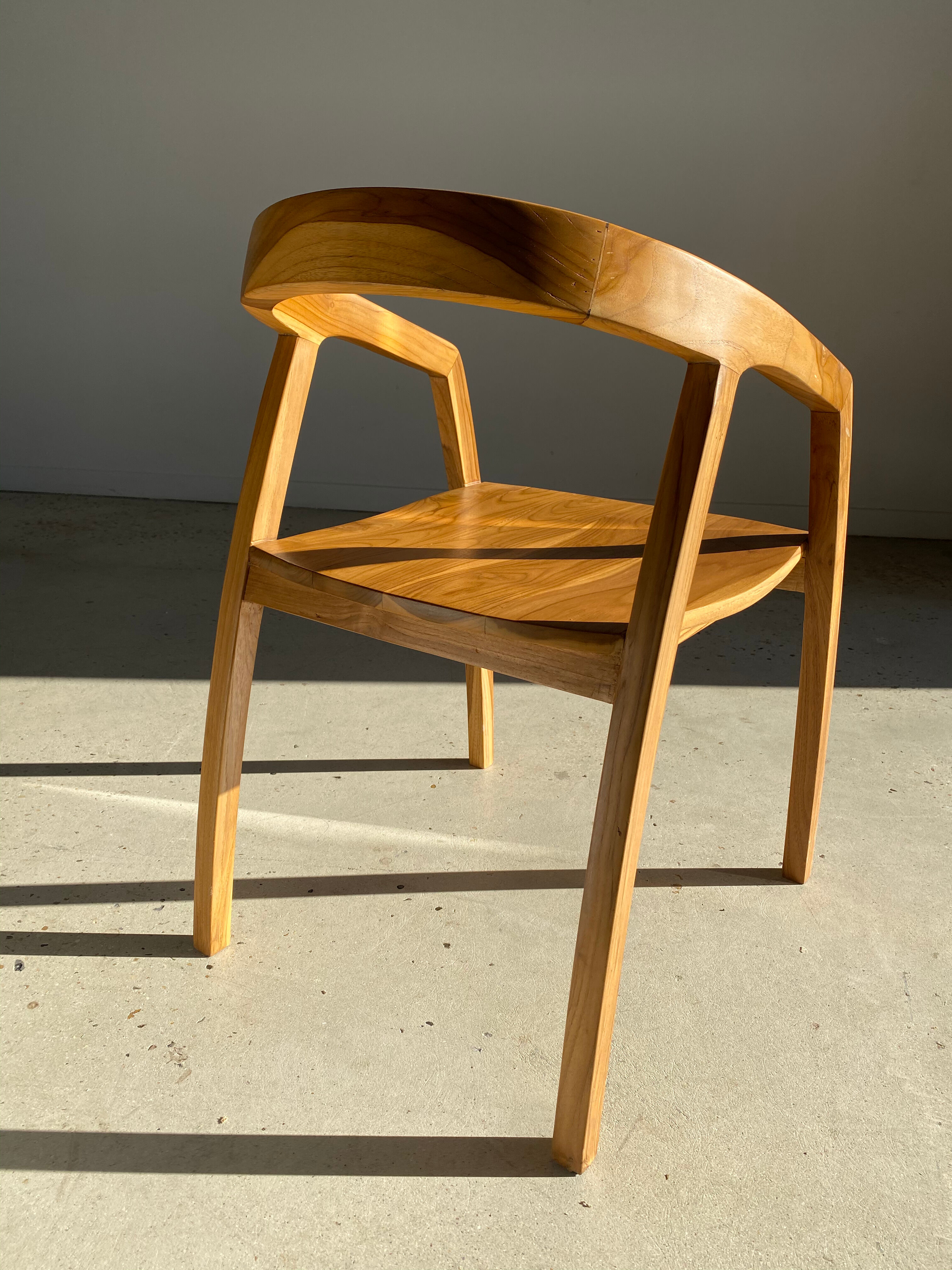 Natural wood chair with wraparound back