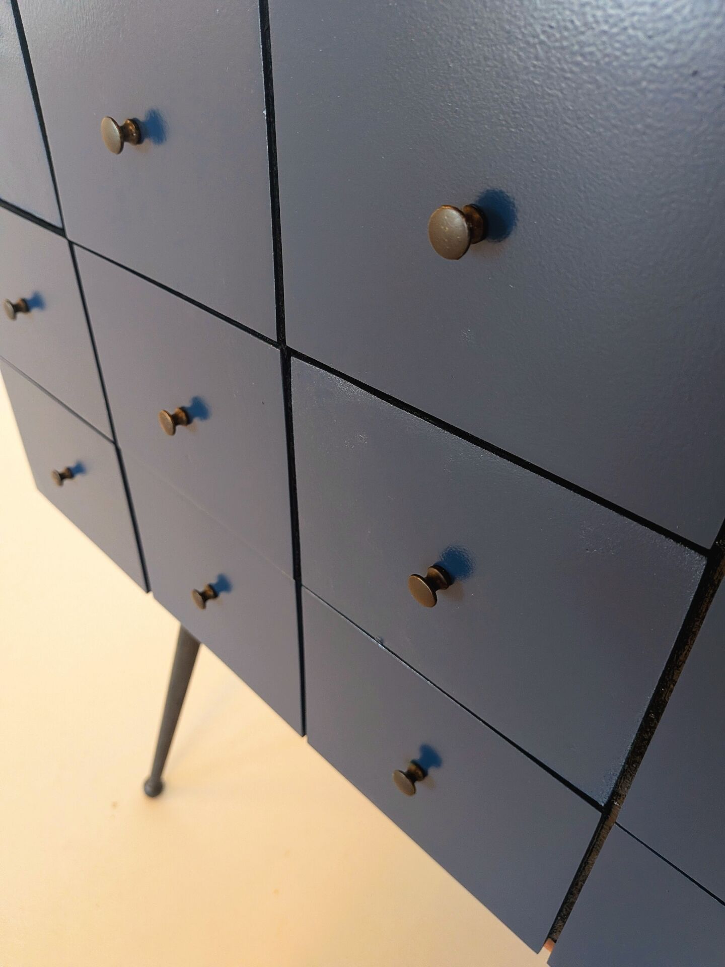 Vintage workshop furniture with 15 blue drawers.
