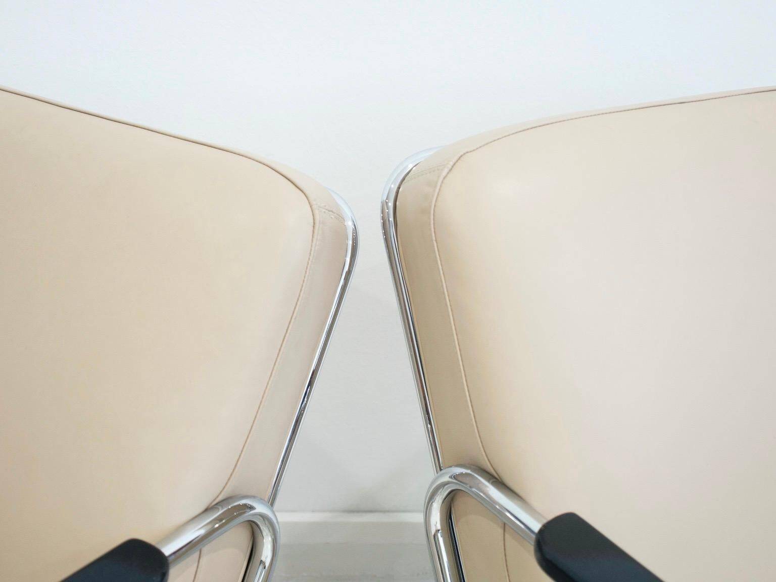 Pair of beige leather and tubular steel armchairs.