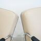 Pair of beige leather and tubular steel armchairs.