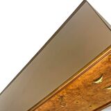 Veneered burl walnut chest of drawers with light warm brown glass top