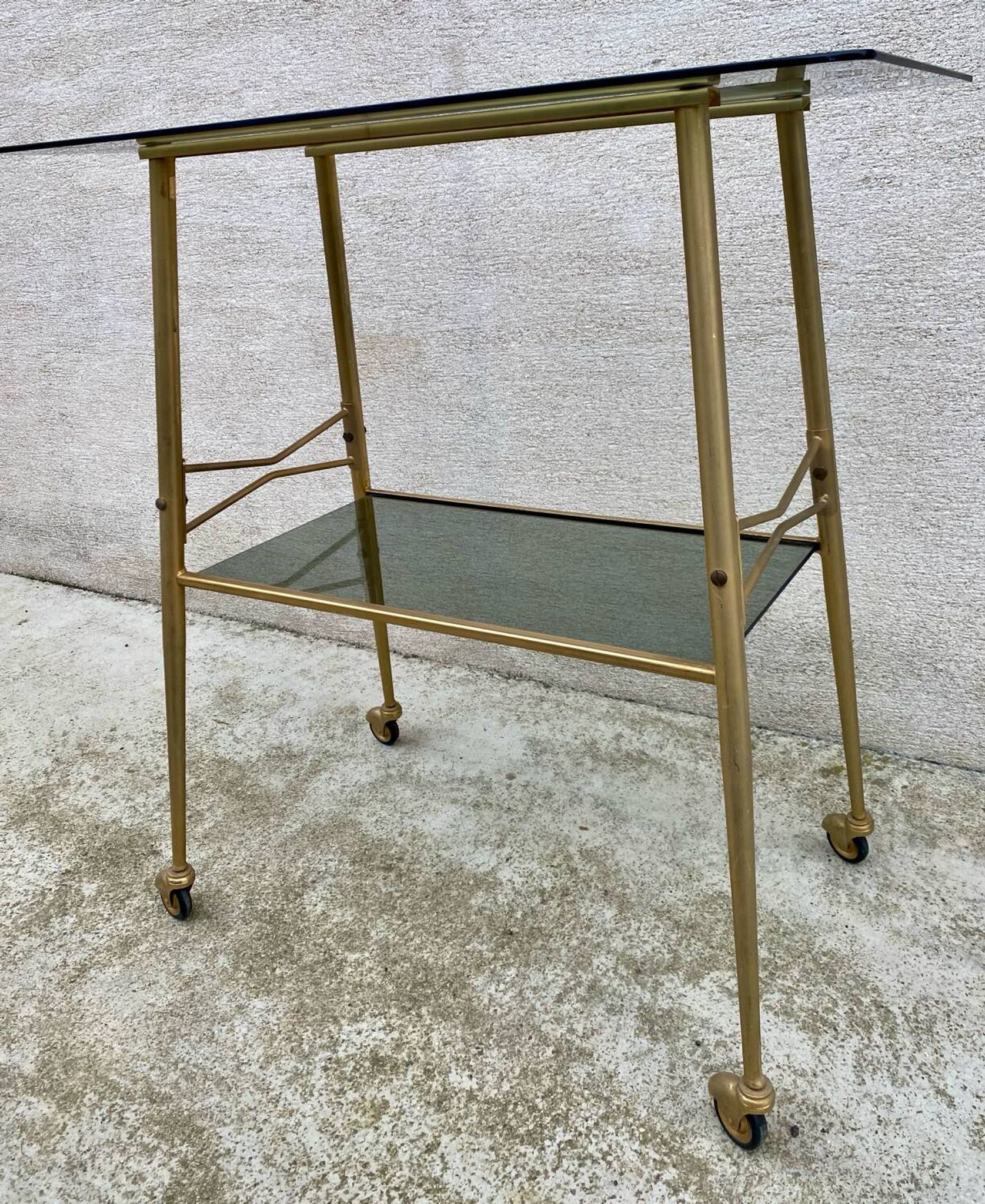 Vintage 1970s glass and gold rolling console table.