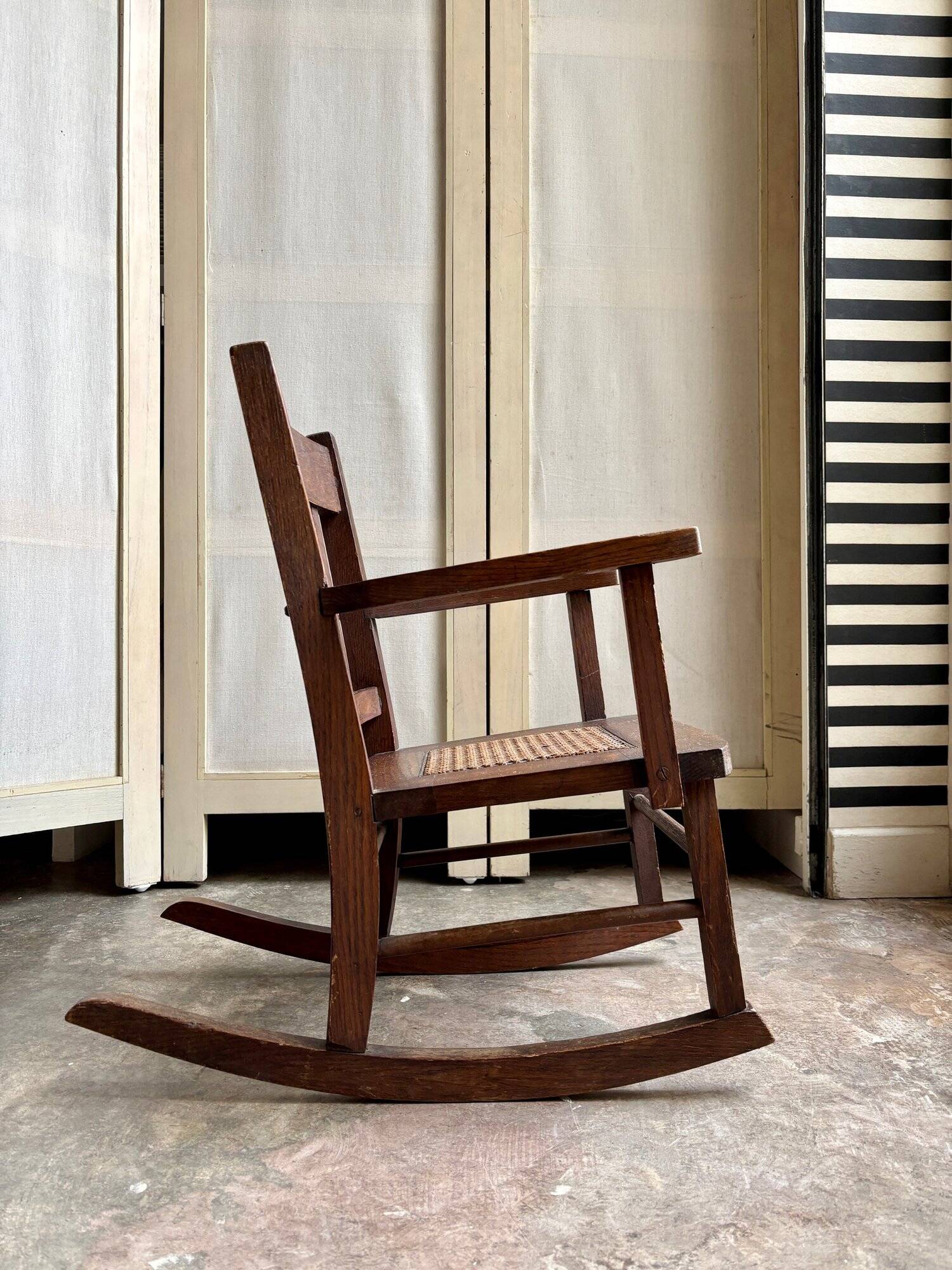 Children's rocking chair in dark wood and cane