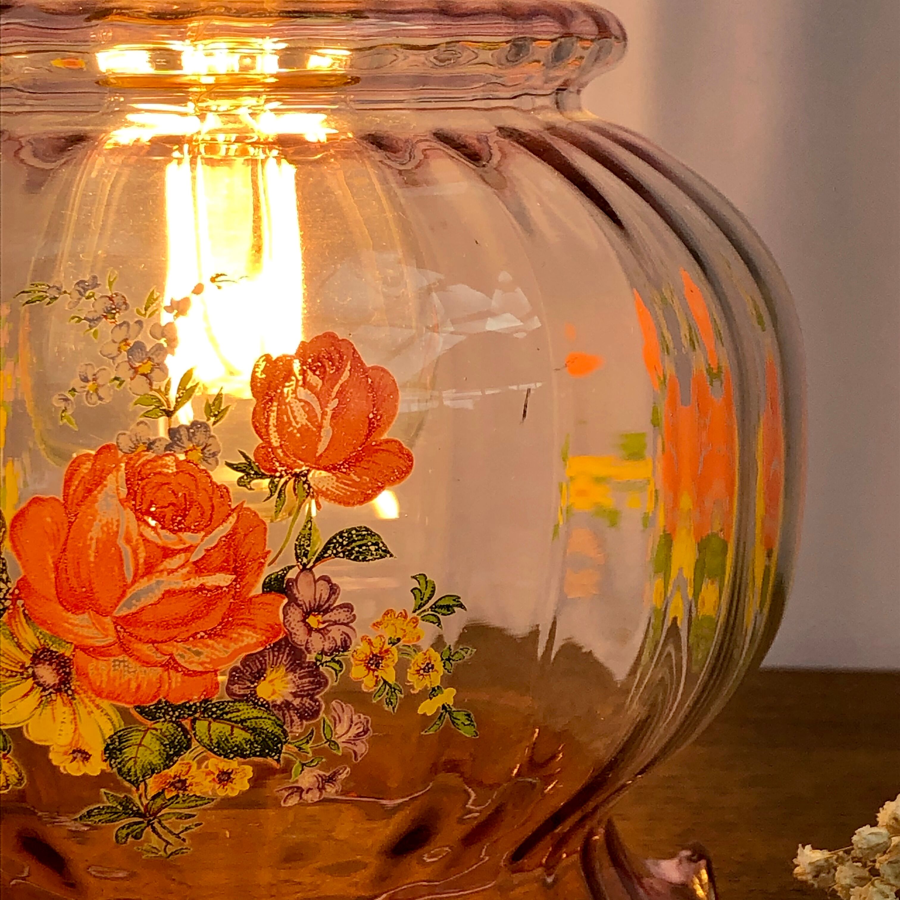 Vintage pink glass hand lamp with flower motifs