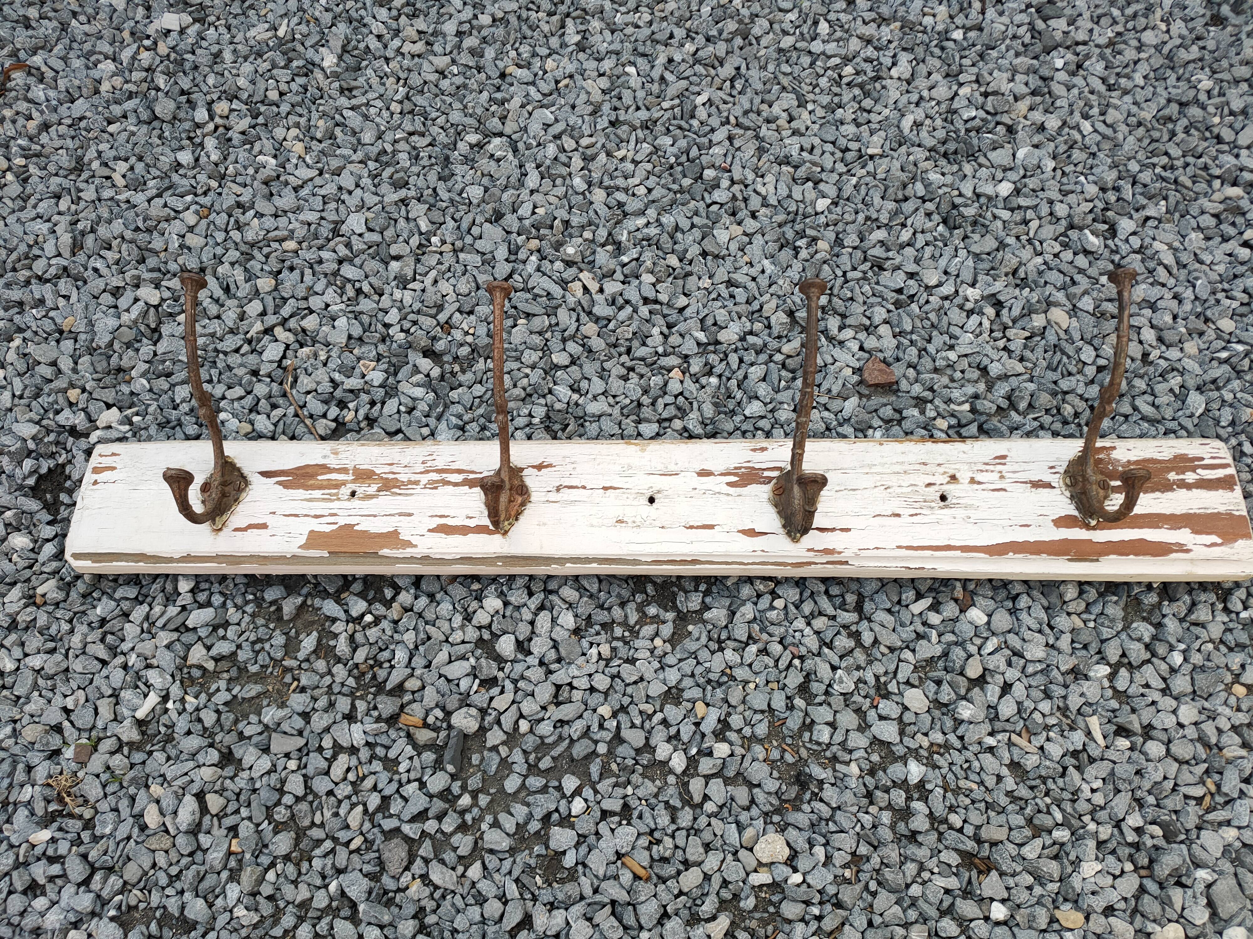antique coat rack with 4 cast iron hooks