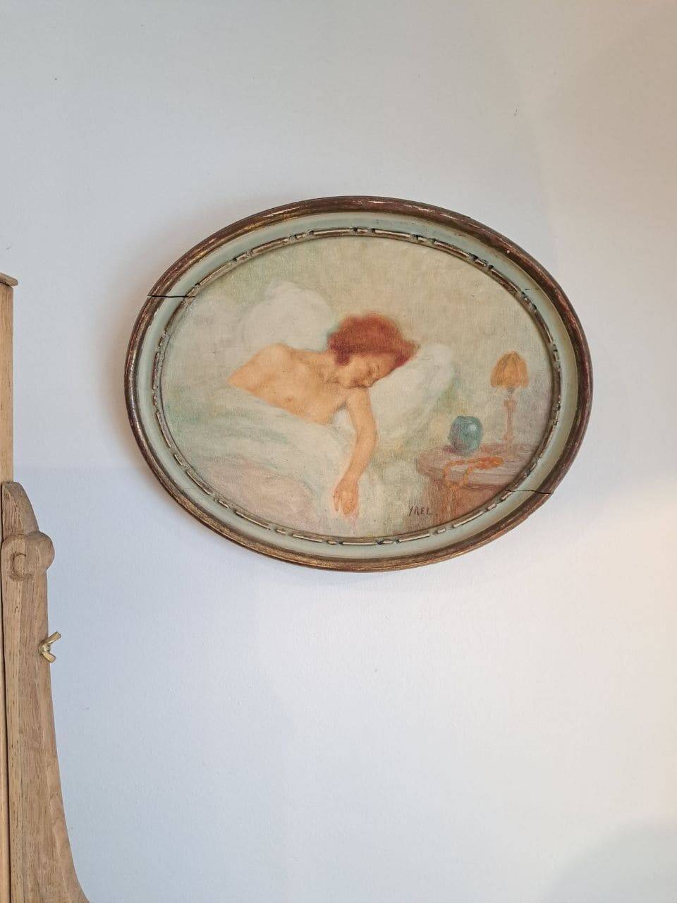 Ancient oval painting of a sleeping woman in oil on wood panel.
