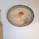Ancient oval painting of a sleeping woman in oil on wood panel.