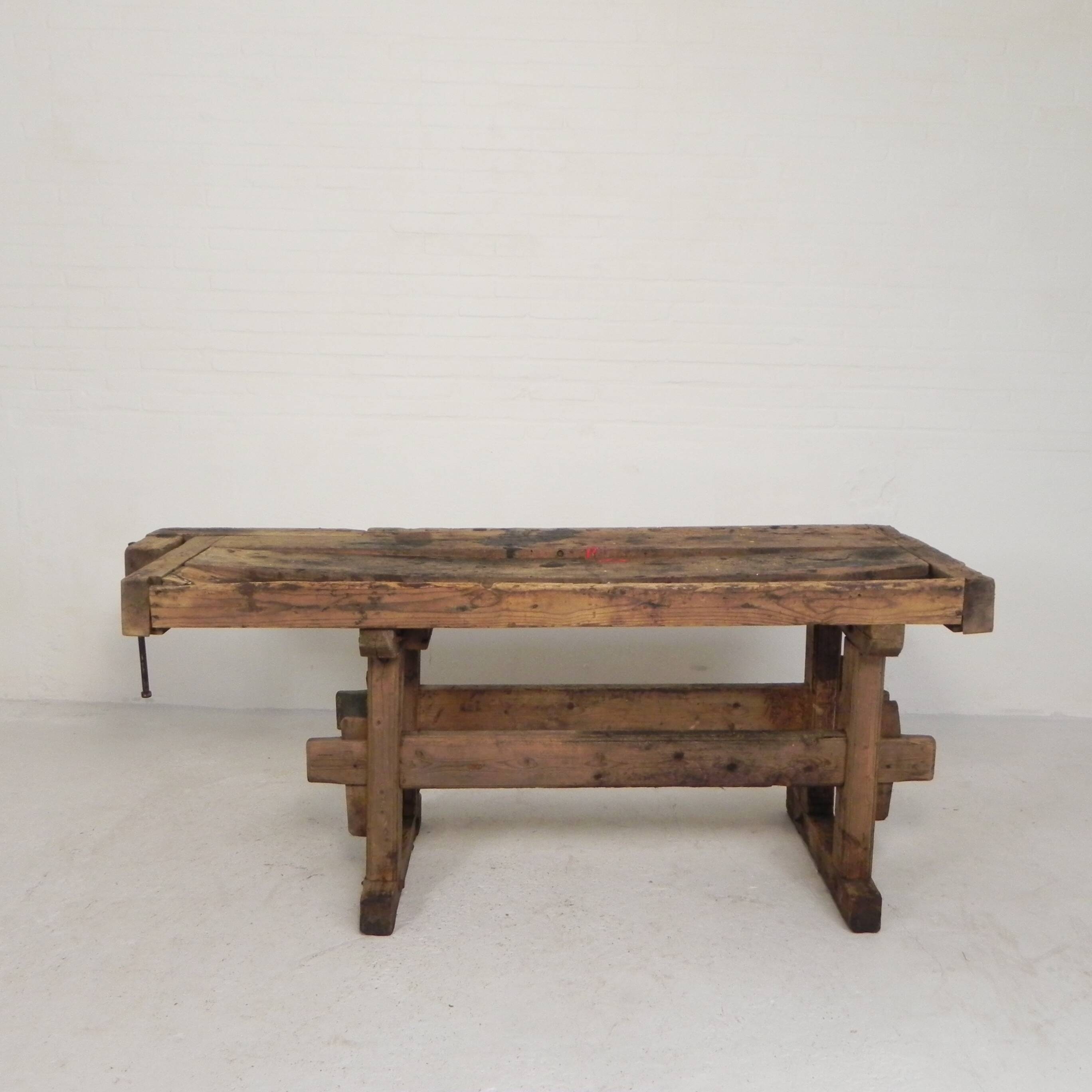 Wooden industrial workbench with vice, 194 cm long, 1930s.
