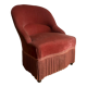 Fauteuil crapaud vintage rose framboise en velours à franges