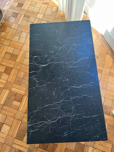 Black marble coffee table with brass legs.
