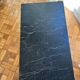 Black marble coffee table with brass legs.