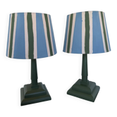 Pair of vintage wooden lamps with their striped beige, blue, and green shades.