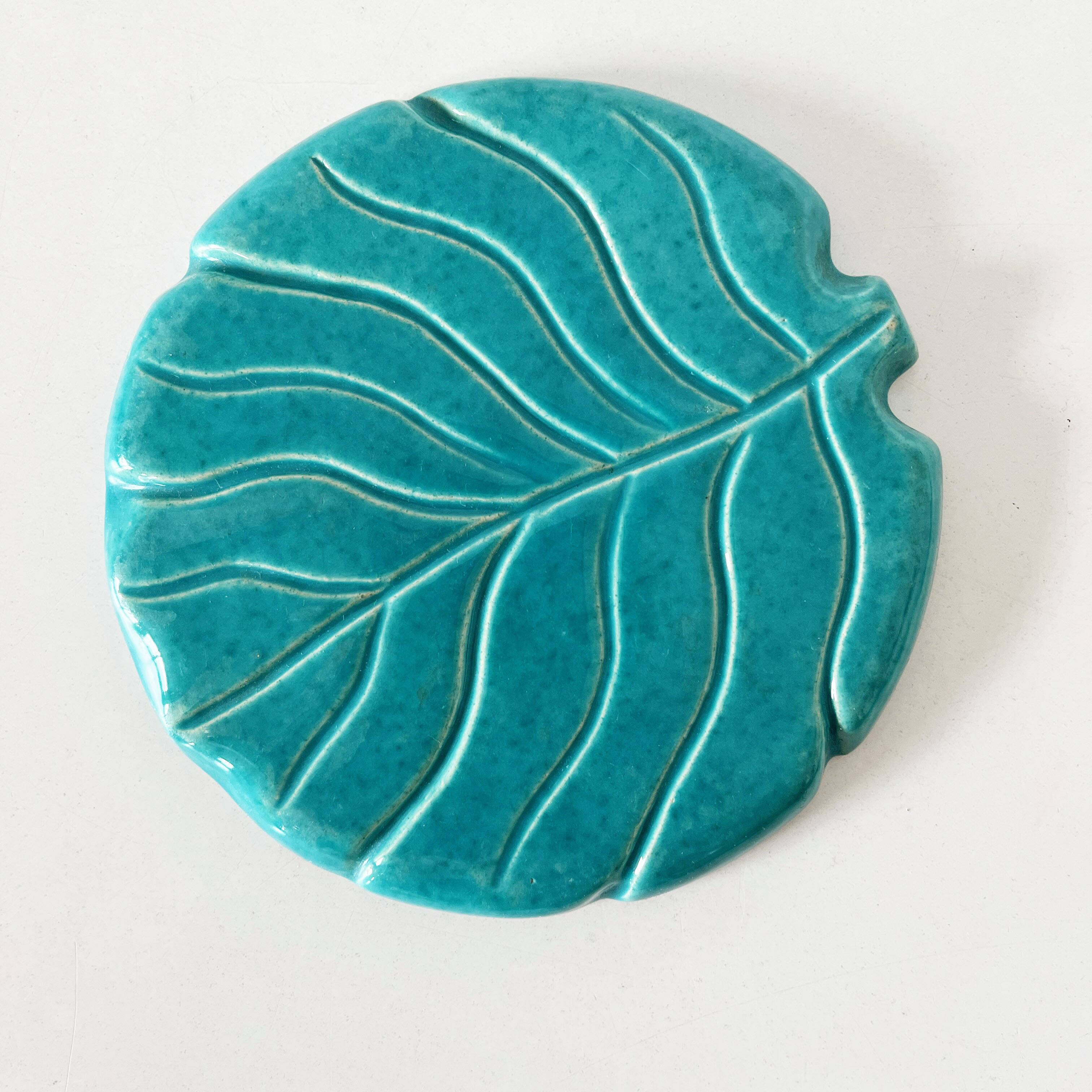 Ceramic trivet and bottle coaster from the 1950s.