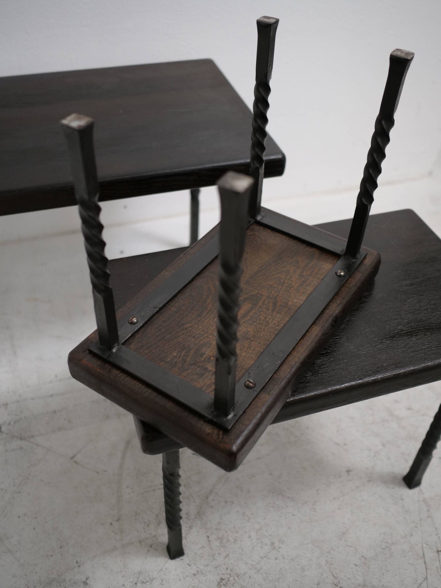 Brutalist nesting table in ebonized oak and wrought iron